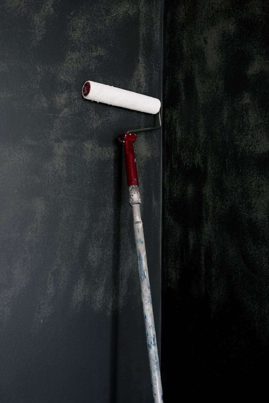 painting roller on wall at home